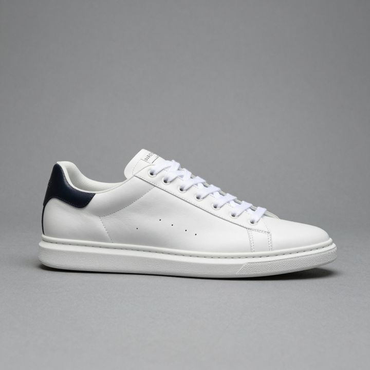 AI-generated product photo of a white leather sneaker, take 2